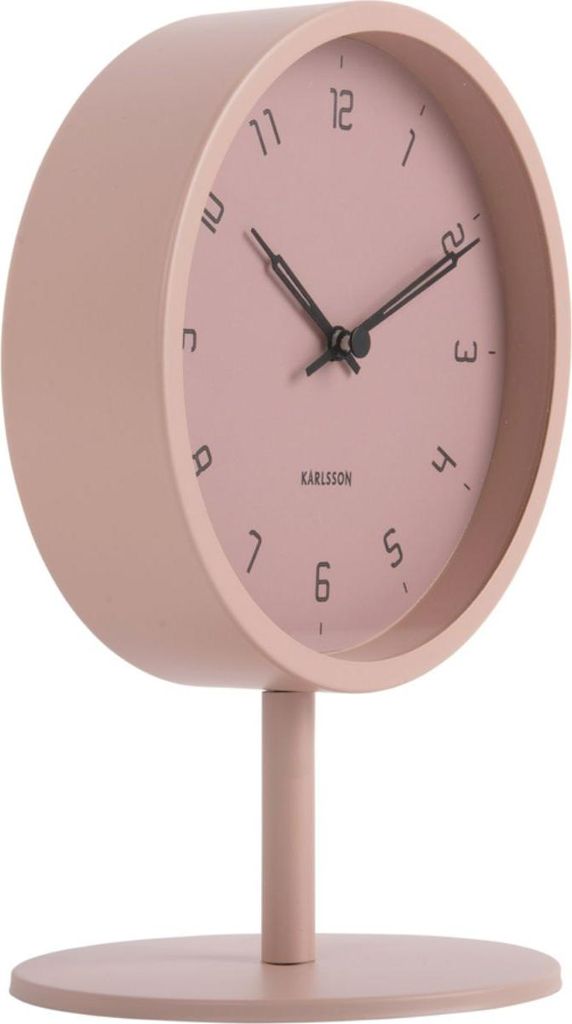 A pink Karlsson table clock on a white background.