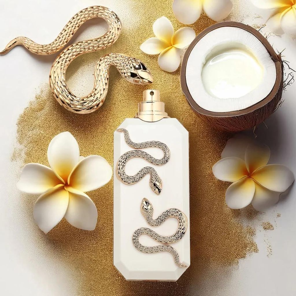 A perfume bottle is displayed with decorative elements like snakes, flowers, and a coconut.