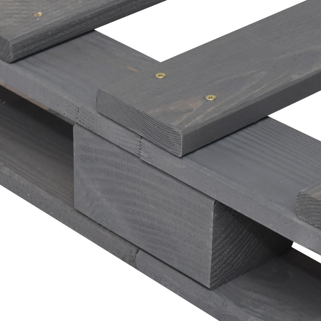A close-up view of the corner of a wooden pallet bed frame, showing the construction details.