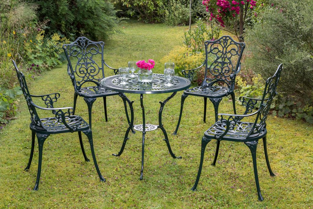 A garden table and four chairs set in a garden setting.