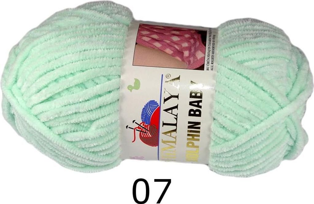 A ball of light green yarn on a white background.