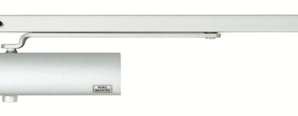 A silver door closer with a sliding arm, mounted on a white background.