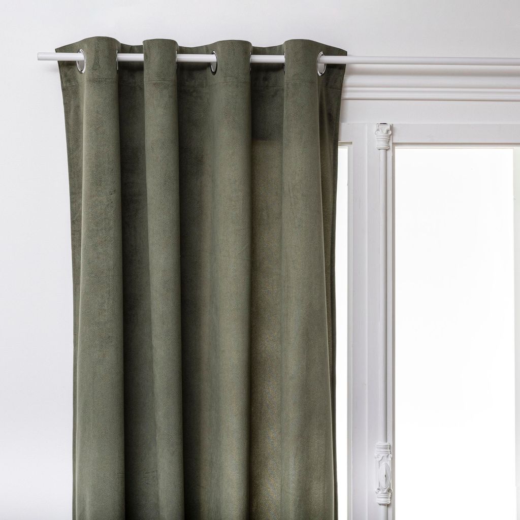 A close-up view of a green curtain hanging from a white curtain rod.