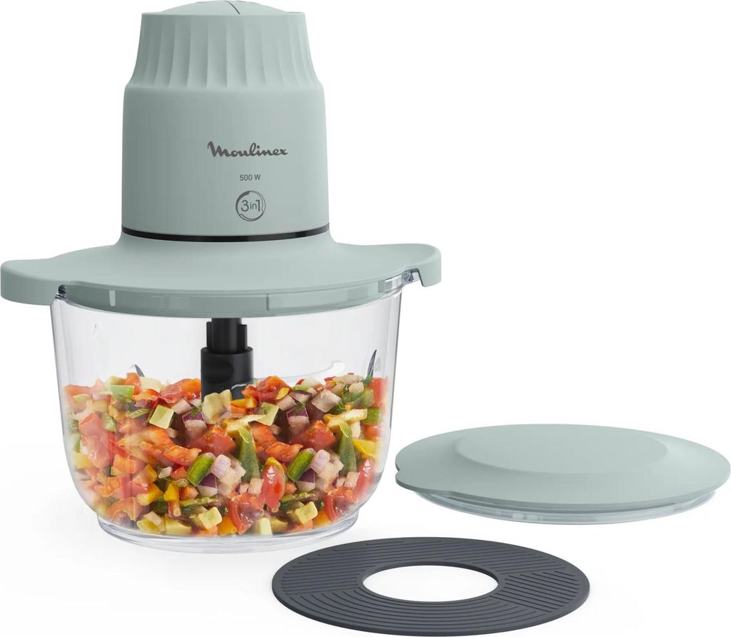 A mint green Moulinex chopper with a clear bowl filled with chopped vegetables, shown with its lid and a separate rubber mat.