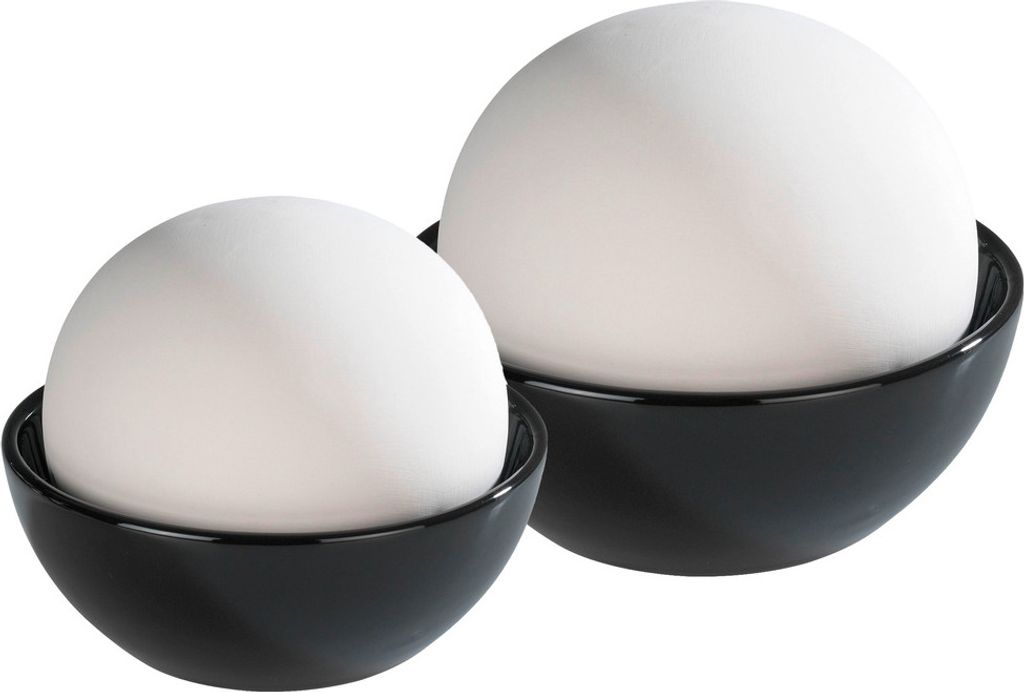 Two white spherical humidifiers sit in black bowls.