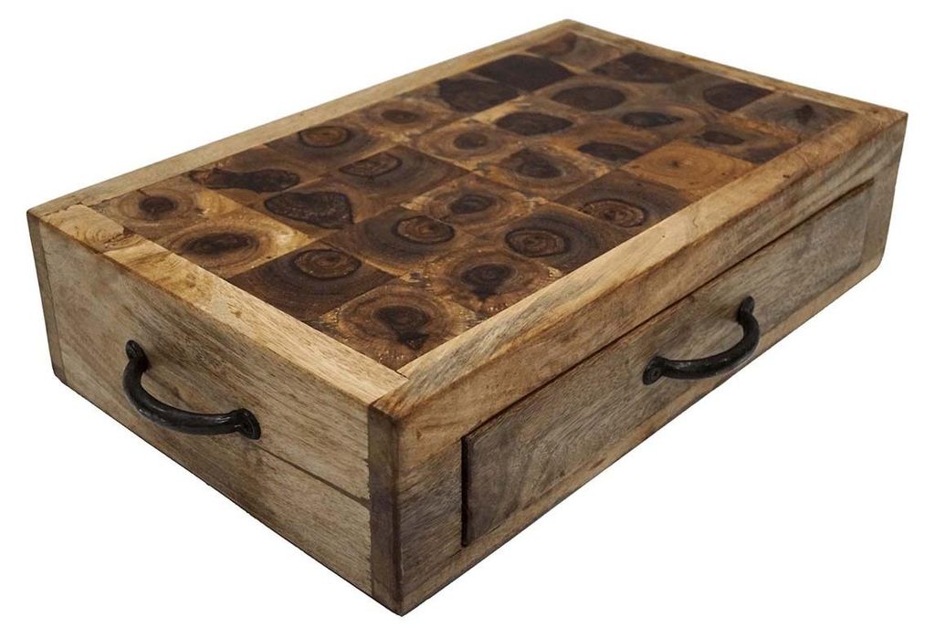 A wooden cutting board with a drawer and a decorative top.