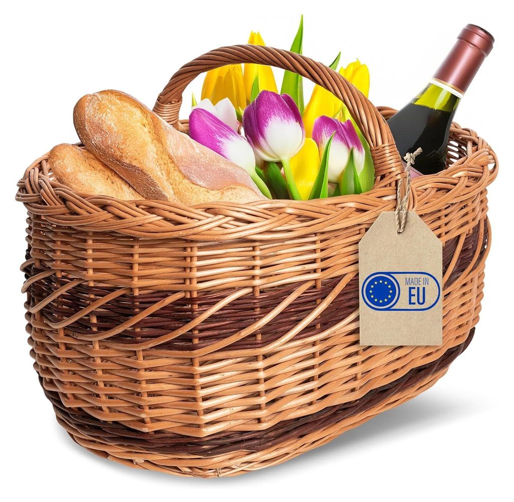 A wicker picnic basket filled with bread, tulips, and a bottle of wine, with a "Made in EU" tag attached.
