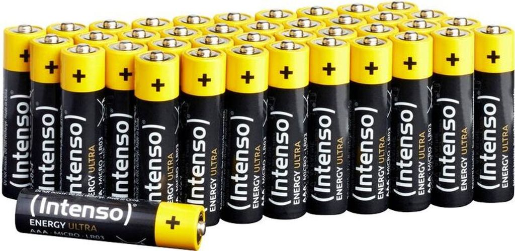 A large group of AAA batteries are neatly arranged in rows.