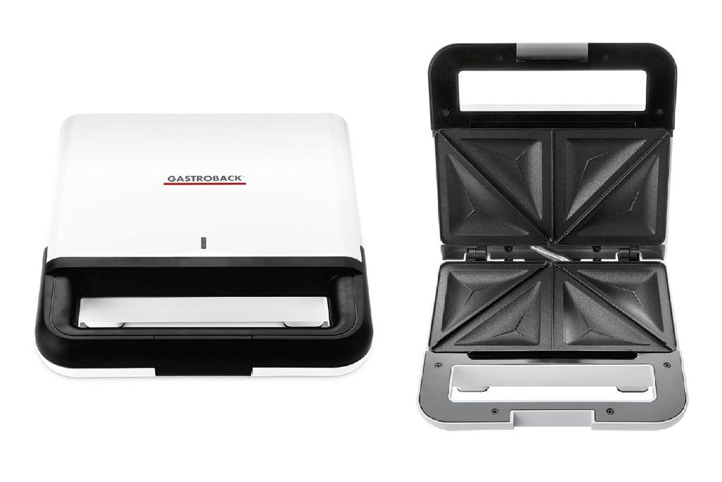 A white and black sandwich maker is shown with its lid open, revealing the cooking plates.