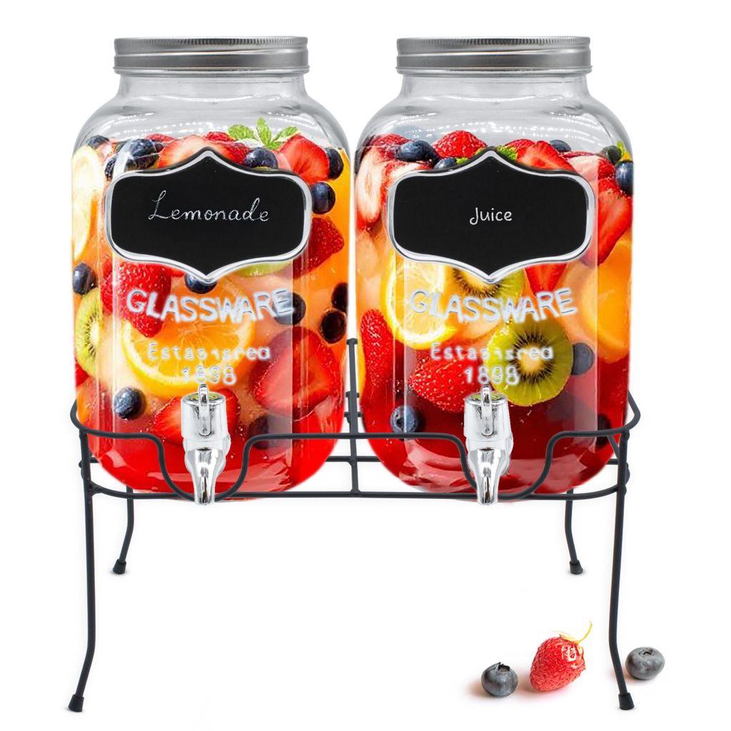 Two glass beverage dispensers filled with fruit and ice, sitting on a black metal stand.