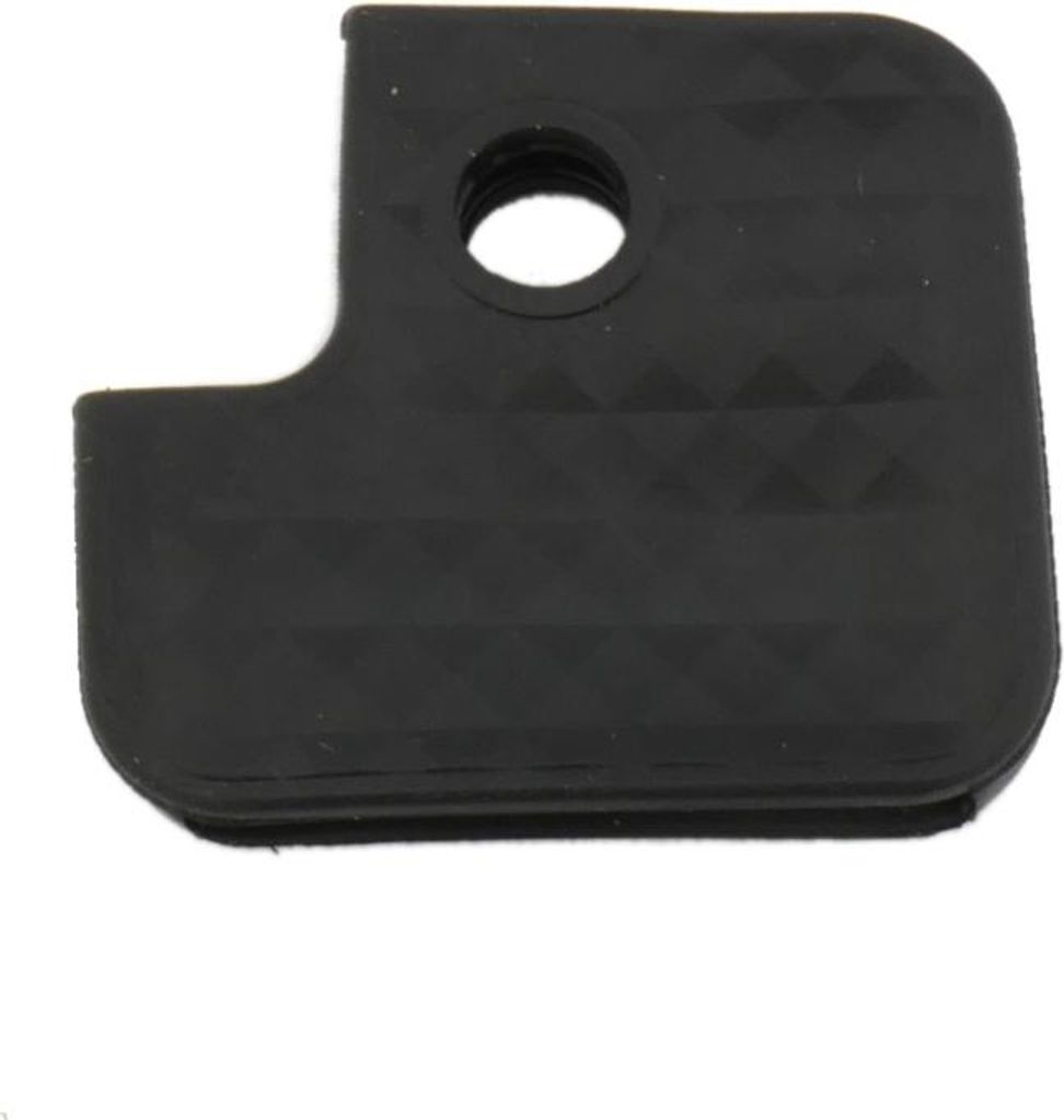 A black keycap with a textured surface and a hole in the corner.