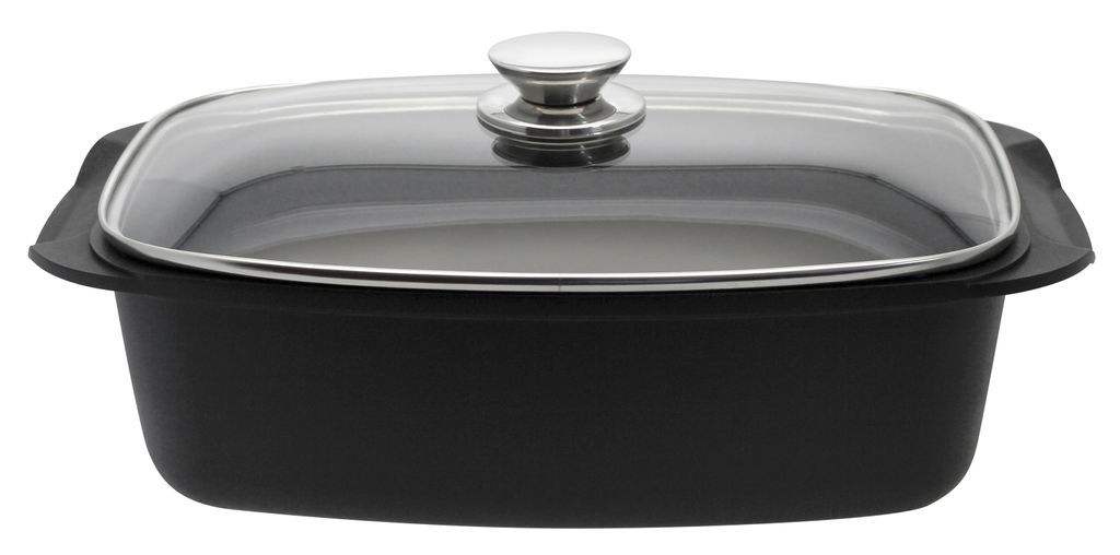 A black roasting pan with a glass lid and a silver handle, shown from a side-angle.