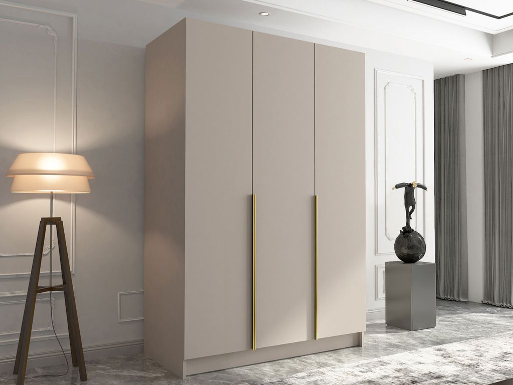 A modern wardrobe with gold handles in a well-lit room.