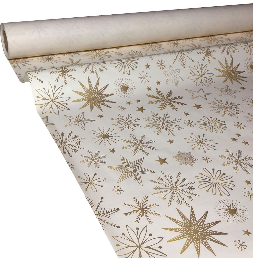 A roll of white paper with a gold snowflake and star pattern, partially unrolled.