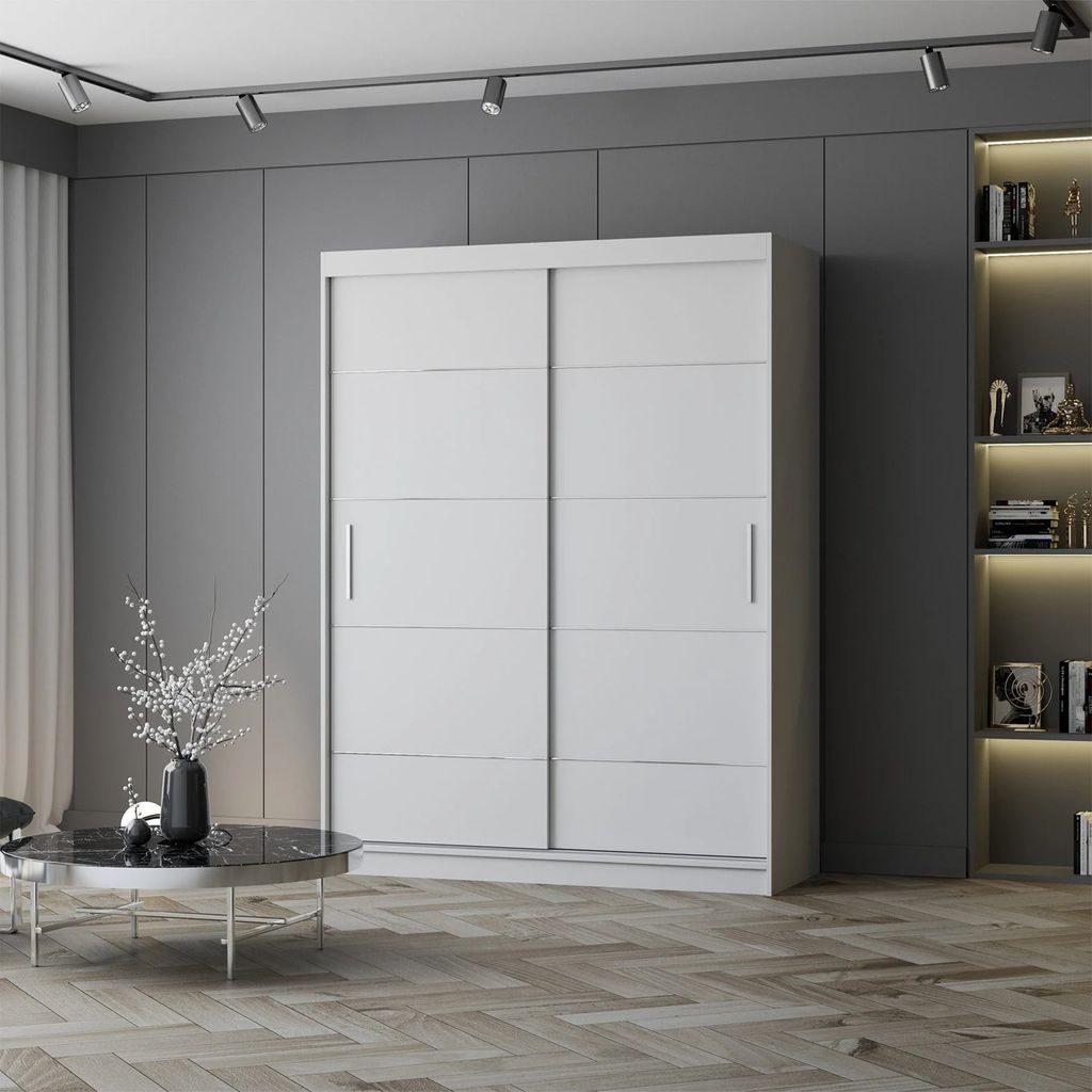 A white sliding door wardrobe is shown in a modern room with a grey wall and wooden floor. A bookshelf with lights is visible on the right.