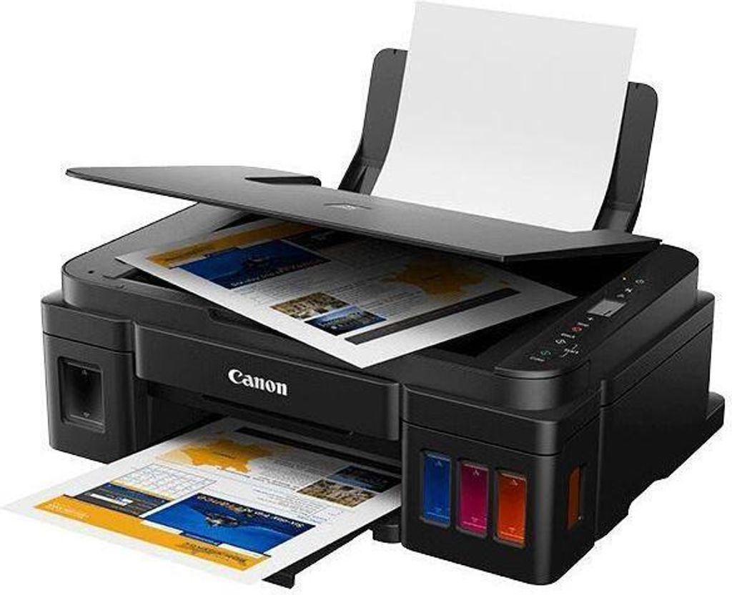 A black Canon PIXMA G2410 printer is shown with paper in the input tray and output tray.