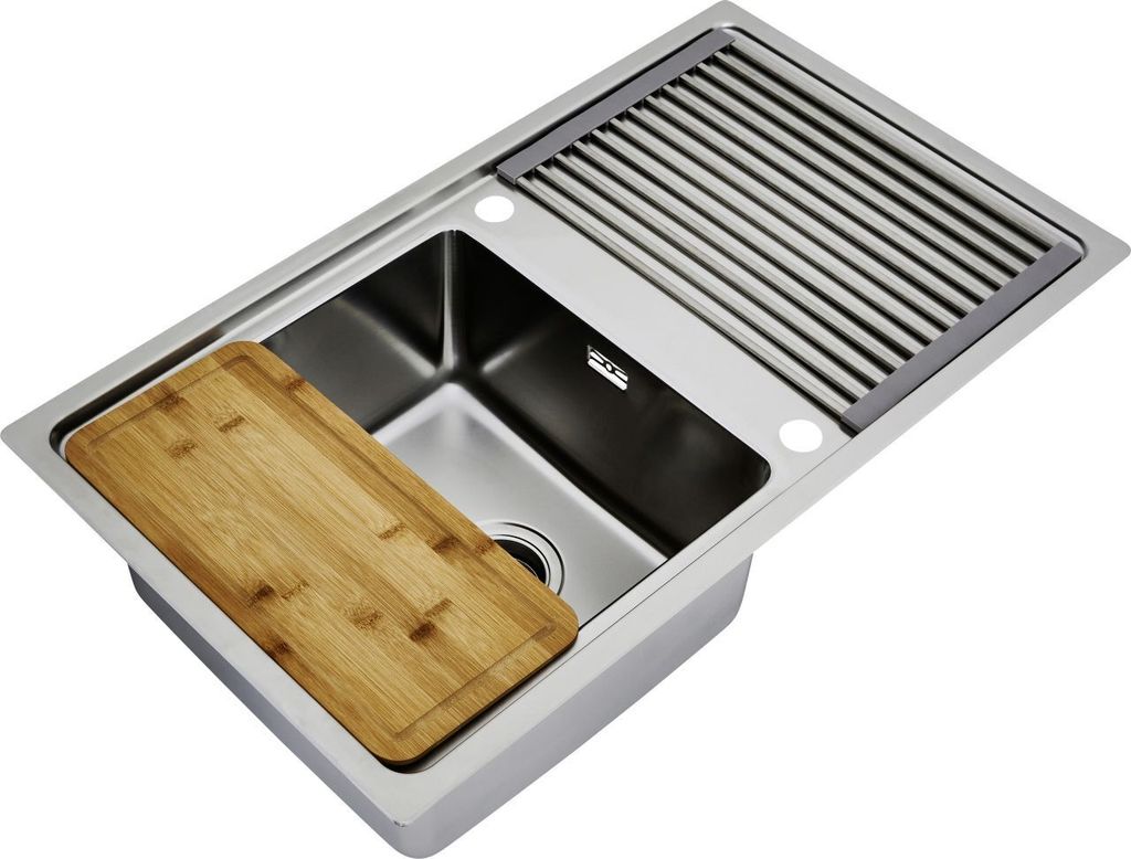 A stainless steel kitchen sink with a wooden cutting board and a drying rack.