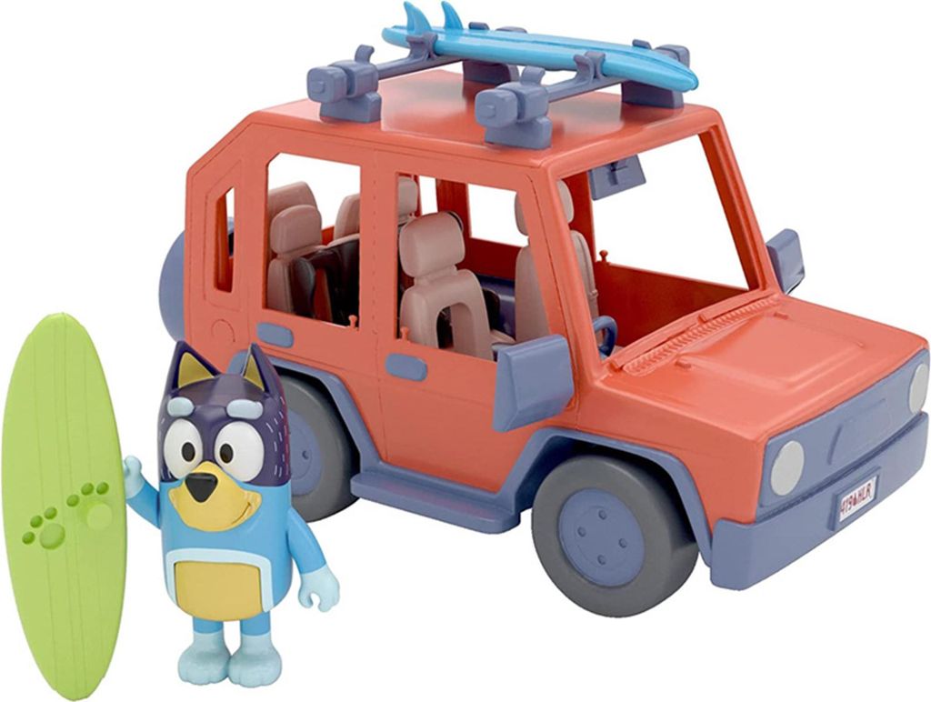A toy Bluey character and a toy car with surfboards on top.