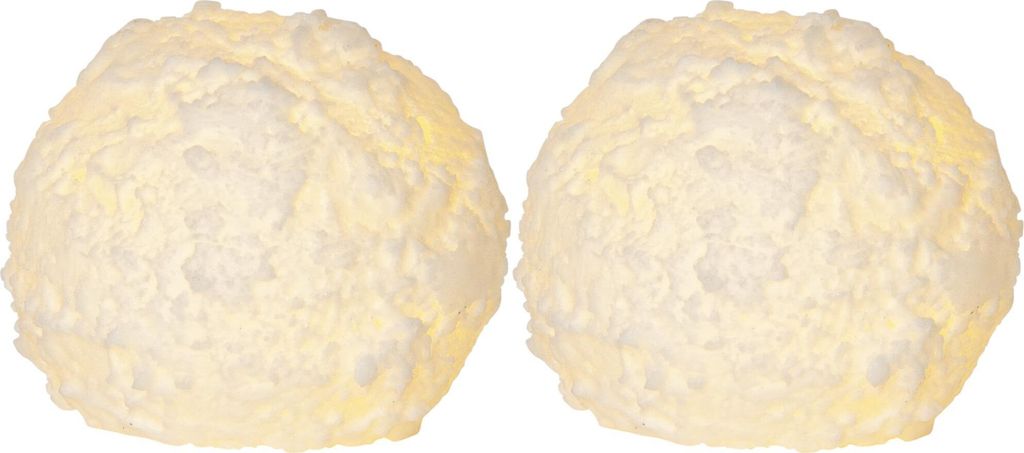 Two white, textured spherical objects resembling snowballs, lit from within.