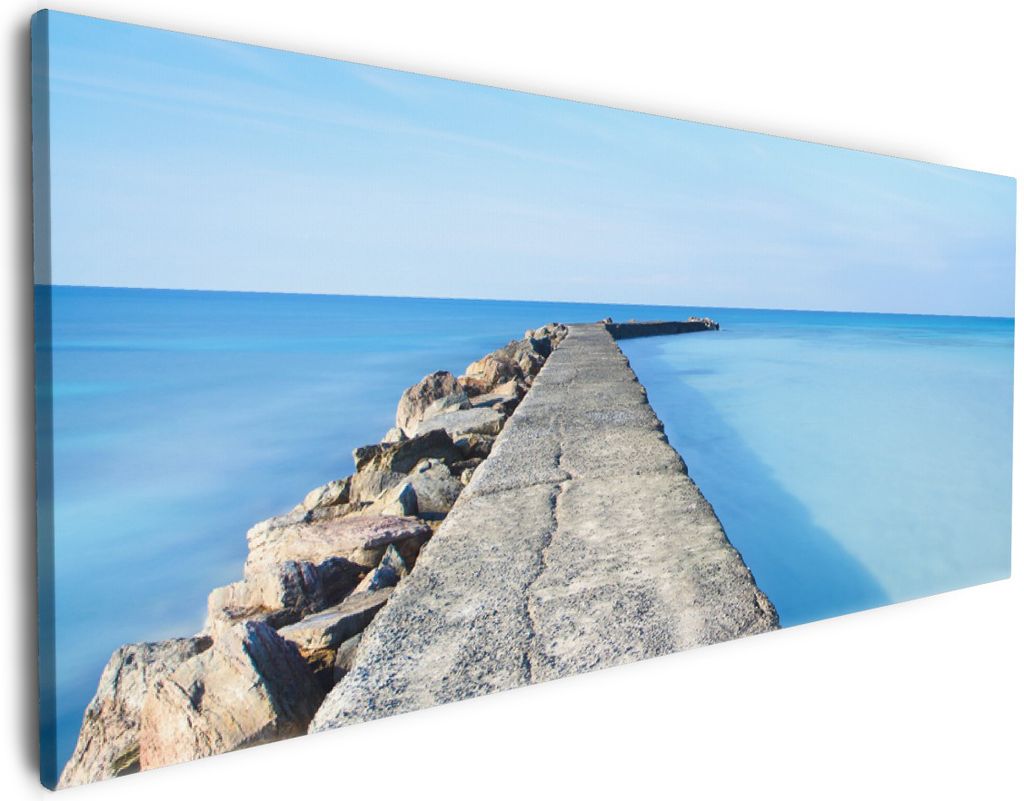 Wallario Premium Leinwandbild Pier am blauen Ozean mit blauem Himmel in Größe 60 x 150 cm