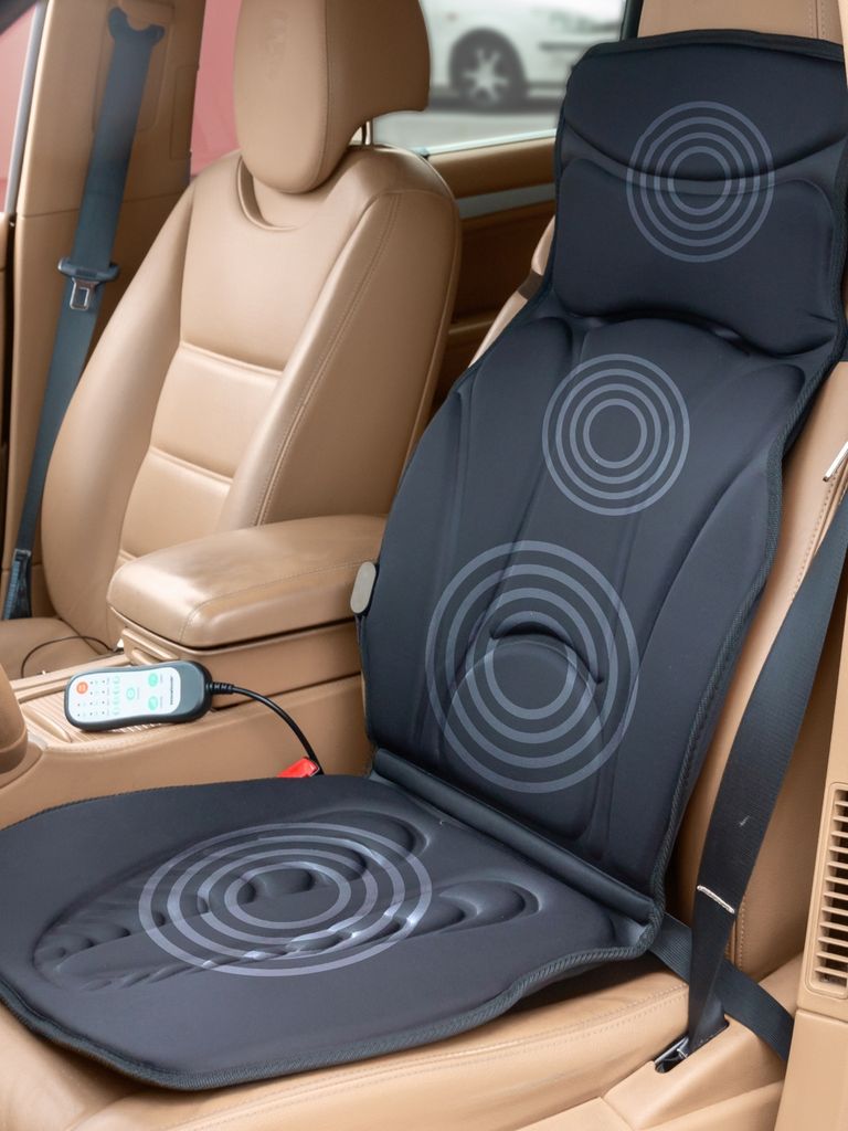 A massage seat mat is placed on a car seat.