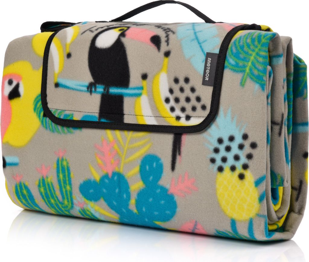 A folded picnic blanket with a tropical pattern.