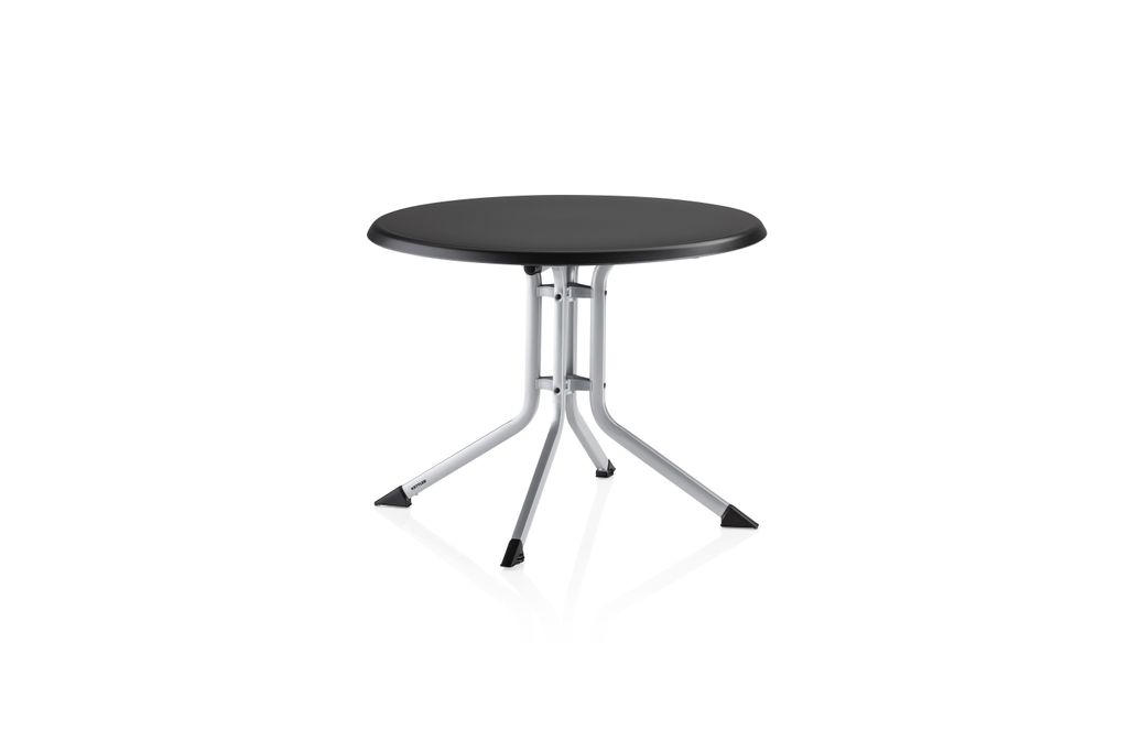 A round, black-topped table with silver legs is shown against a white background.