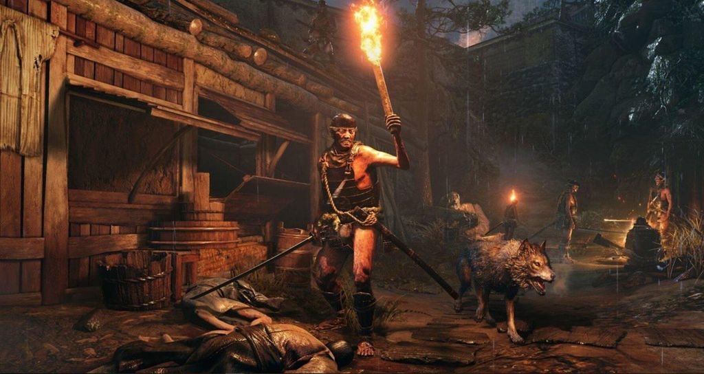 A warrior with a torch and a wolf in a dark, rustic village setting.
