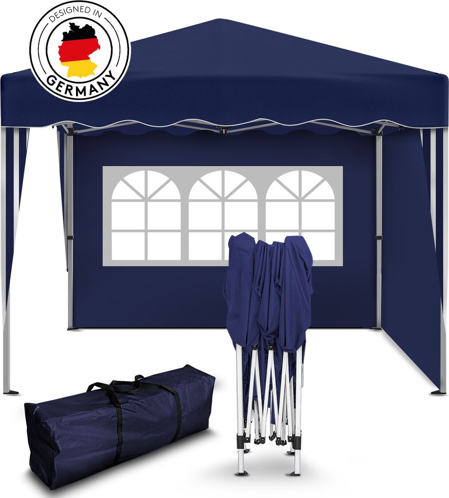 A navy blue pop-up tent is shown, partially assembled, with a carrying bag and folded frame in the foreground. The tent has arched windows.