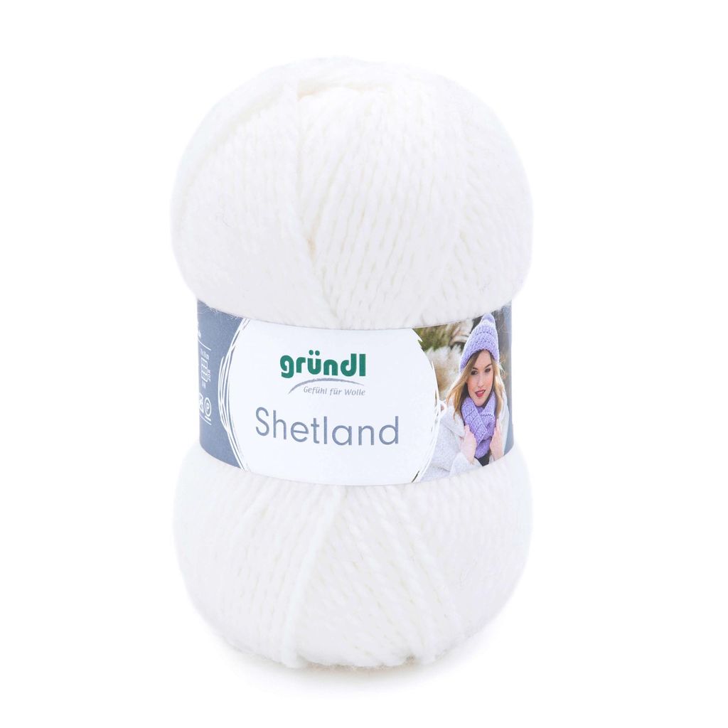 A ball of white yarn with a label showing a person wearing a hat and scarf.