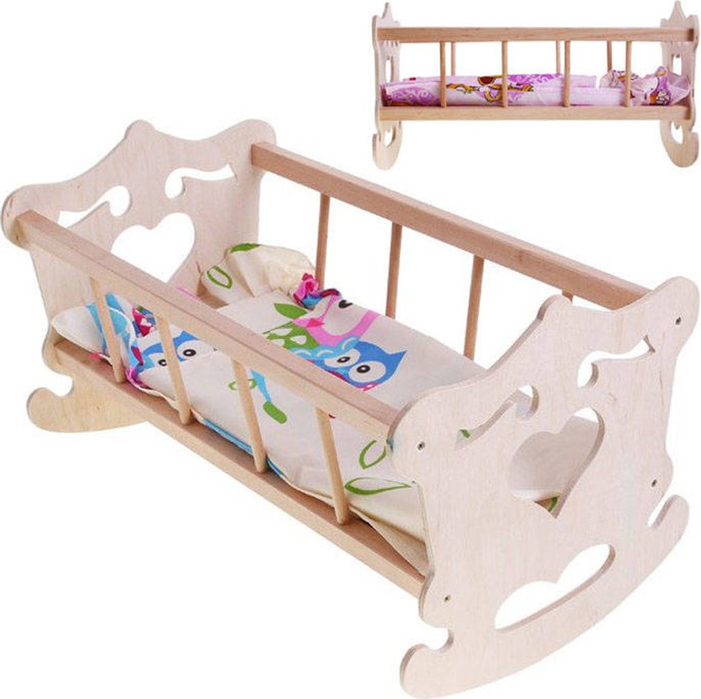 A wooden doll cradle with bedding, shown from a slightly elevated angle.