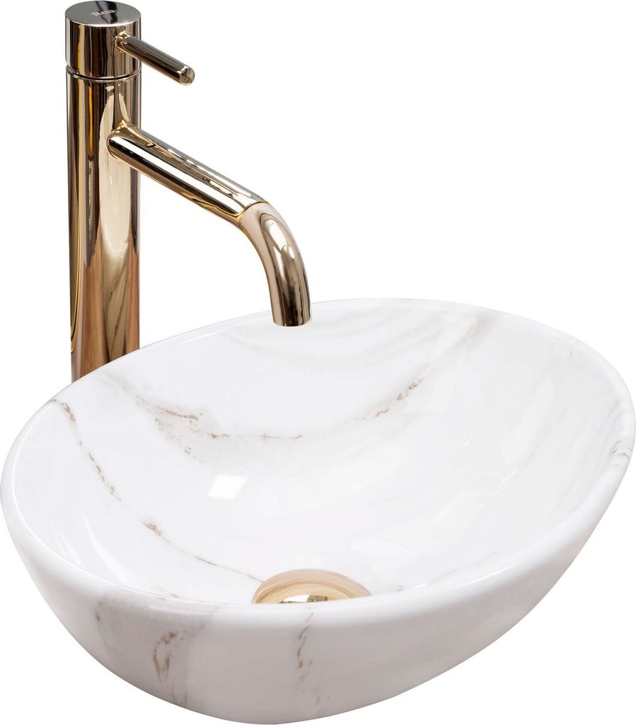 A close-up studio shot of a white marble-patterned vessel sink with a gold faucet.