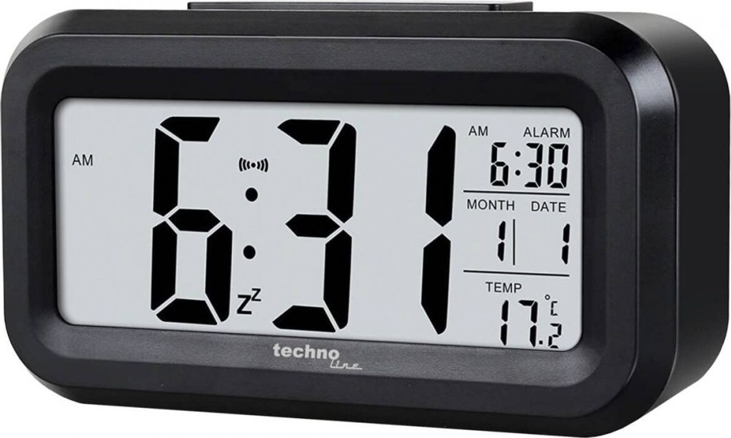 A black digital alarm clock with a white display showing the time, date, and temperature.