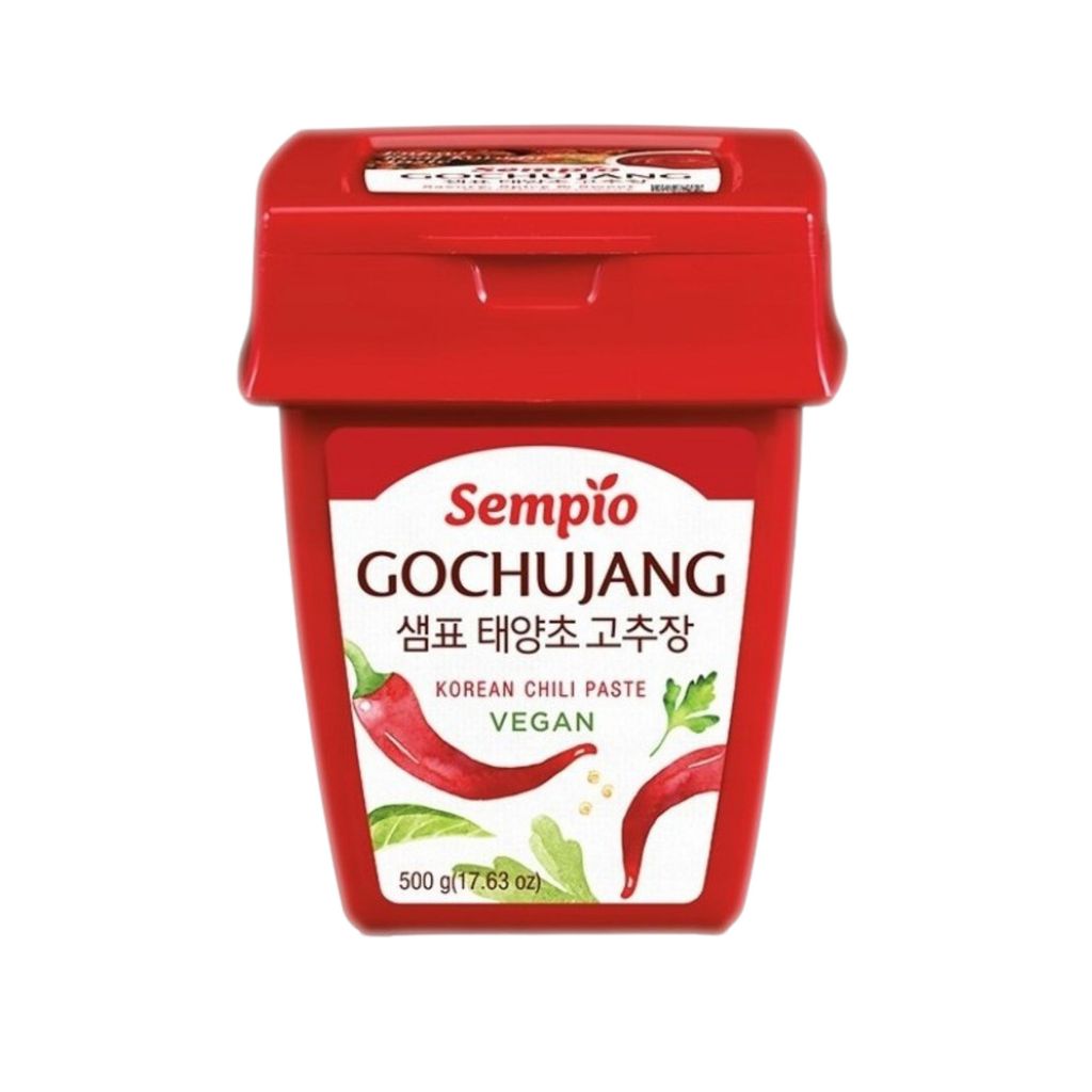 A red tub of Gochujang Korean chili paste against a white background.