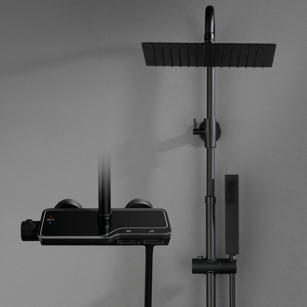 A modern black shower set mounted on a gray wall.