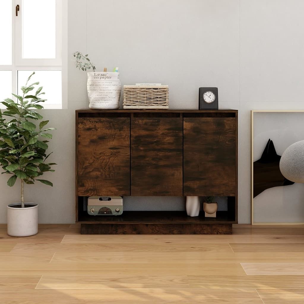 A wooden sideboard with three doors and open shelves below, placed in a room with a window and a plant.