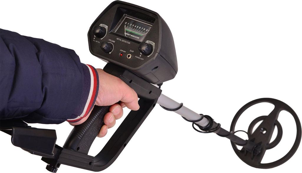 A hand holding a metal detector against a white background.