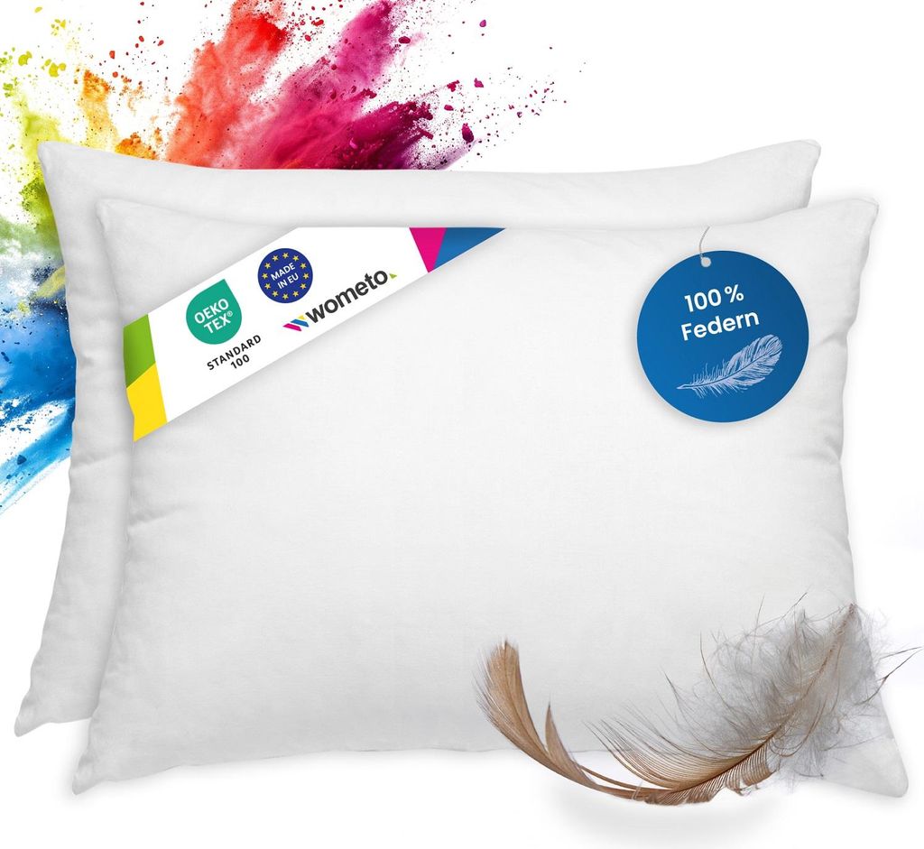 Two white feather pillows are shown with colorful powder splashes in the background.