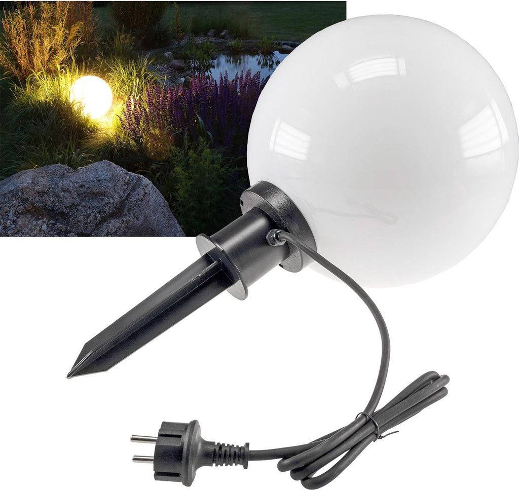 A garden light in a natural outdoor setting at night.