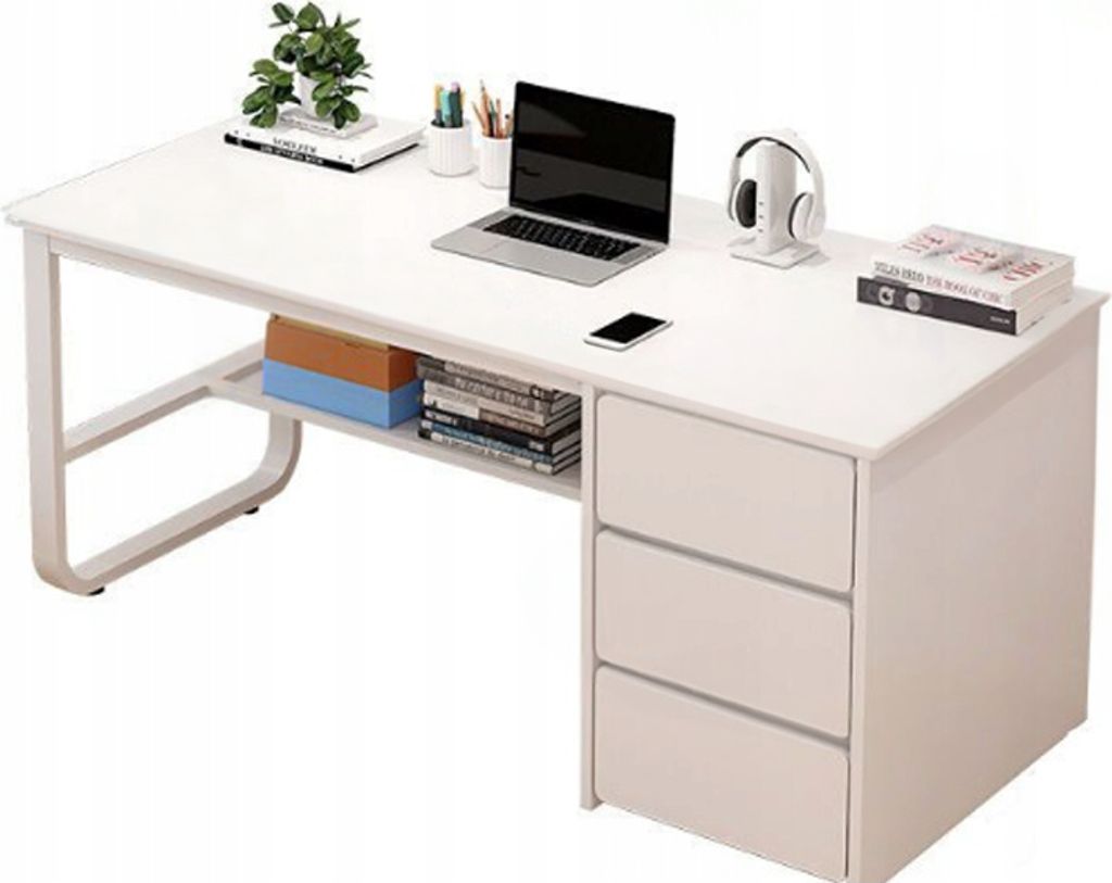 A white desk with a laptop, headphones, books, and a plant.