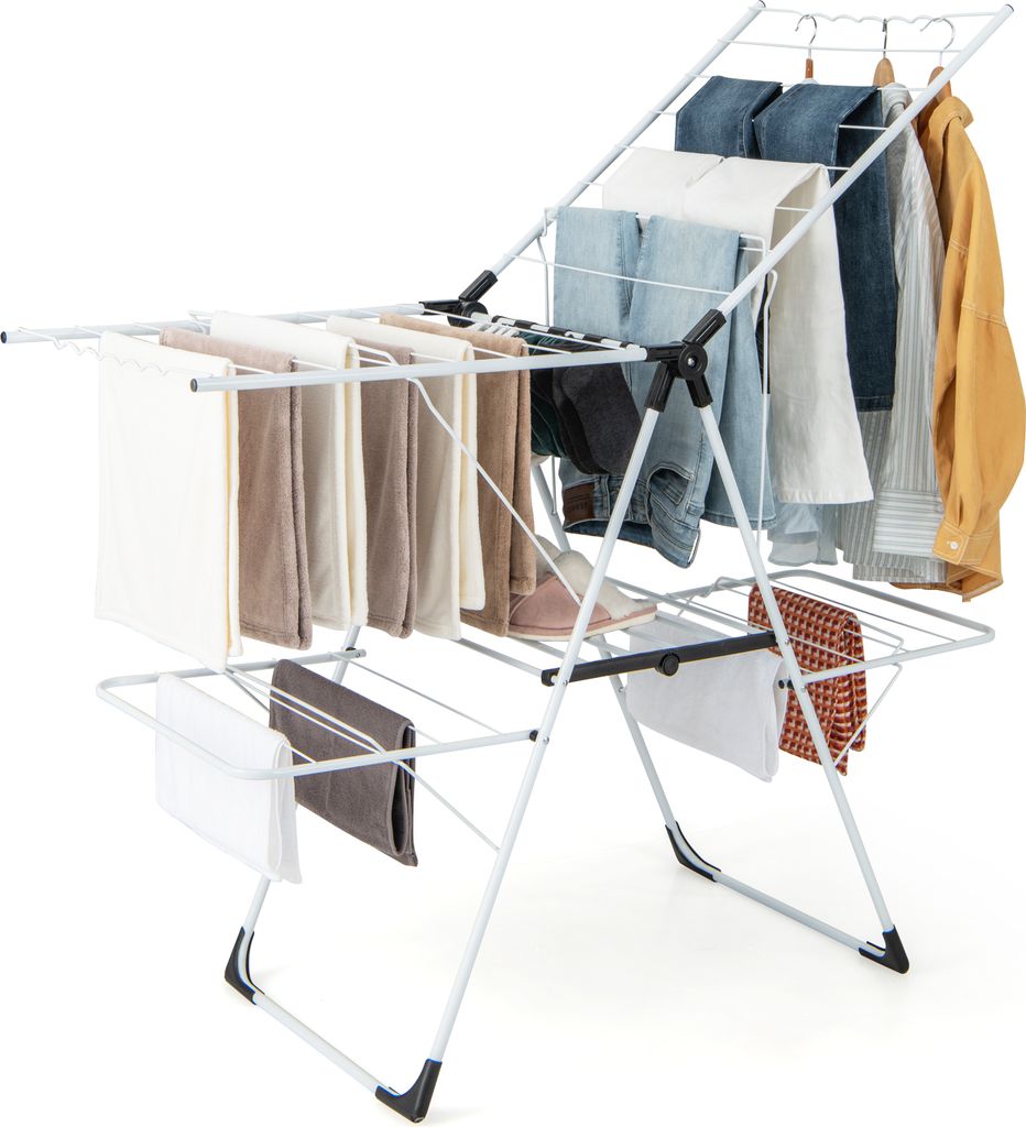 A white, foldable, multi-tiered clothes drying rack with various garments hanging on it.