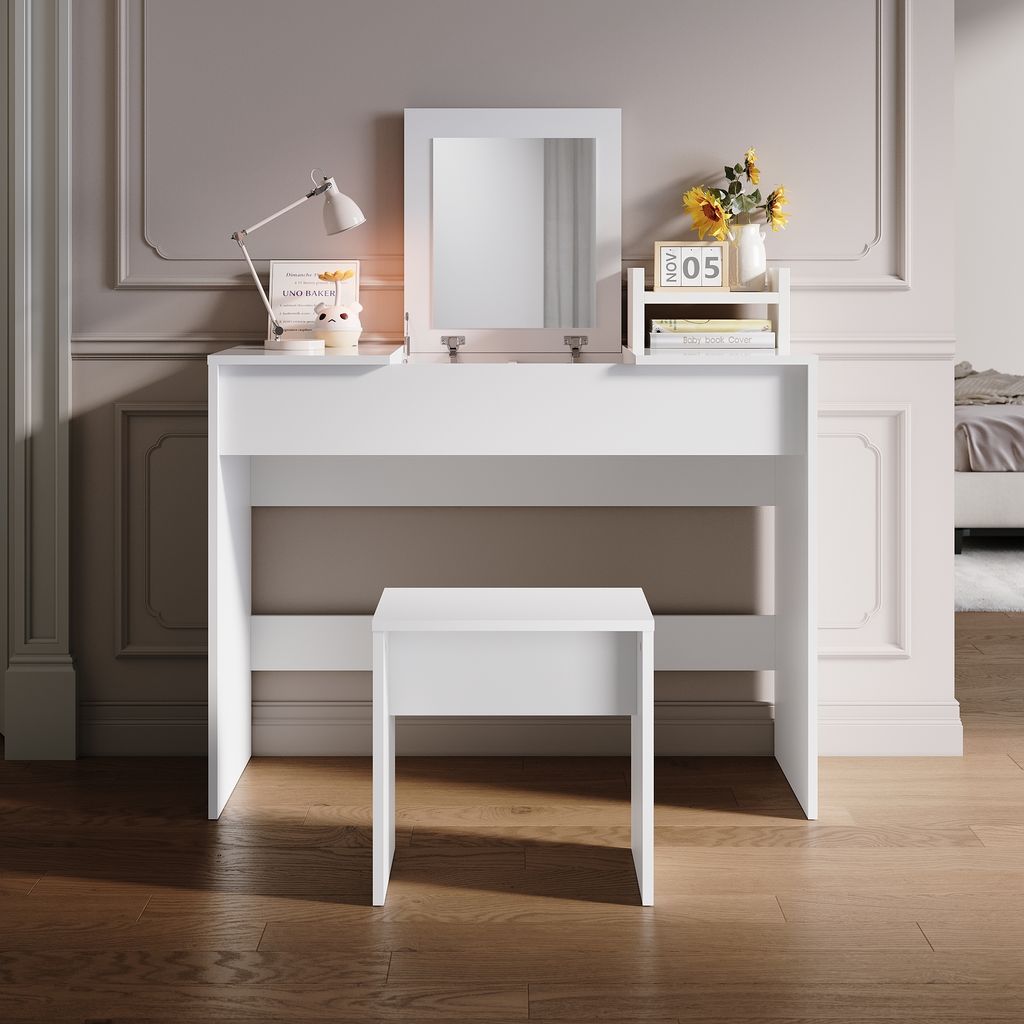 A white vanity table with a mirror and a stool in a room with decorative wall molding.
