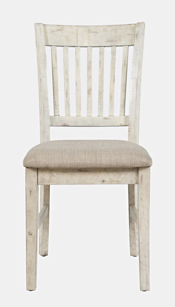 A front view of a distressed white wooden dining chair with a tan fabric seat.