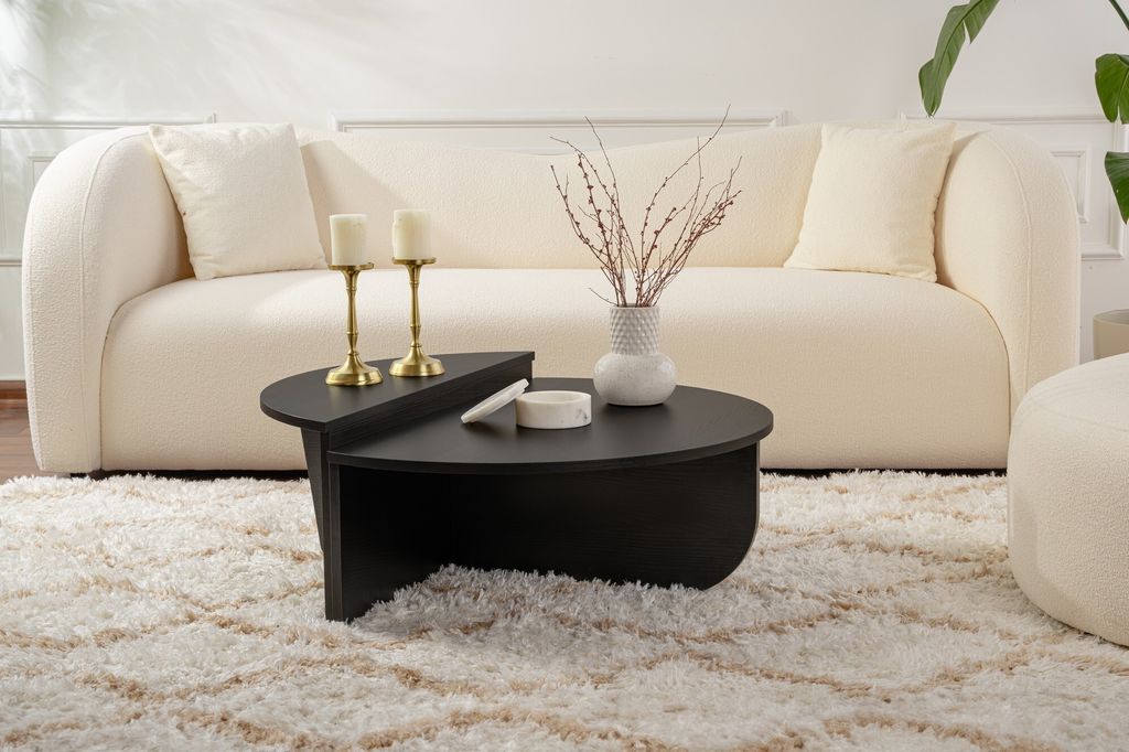 A modern living room scene with a couch, coffee table, and rug.