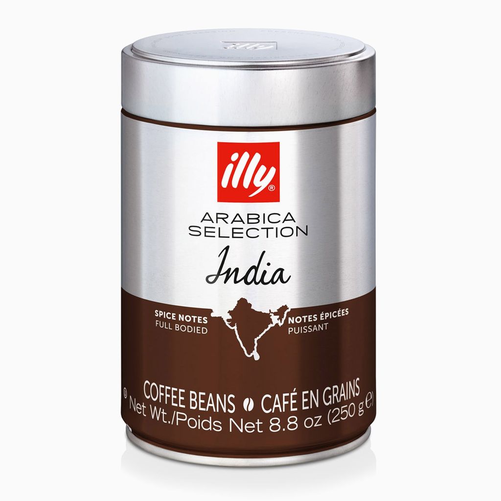 A cylindrical tin of illy Arabica Selection India coffee beans.