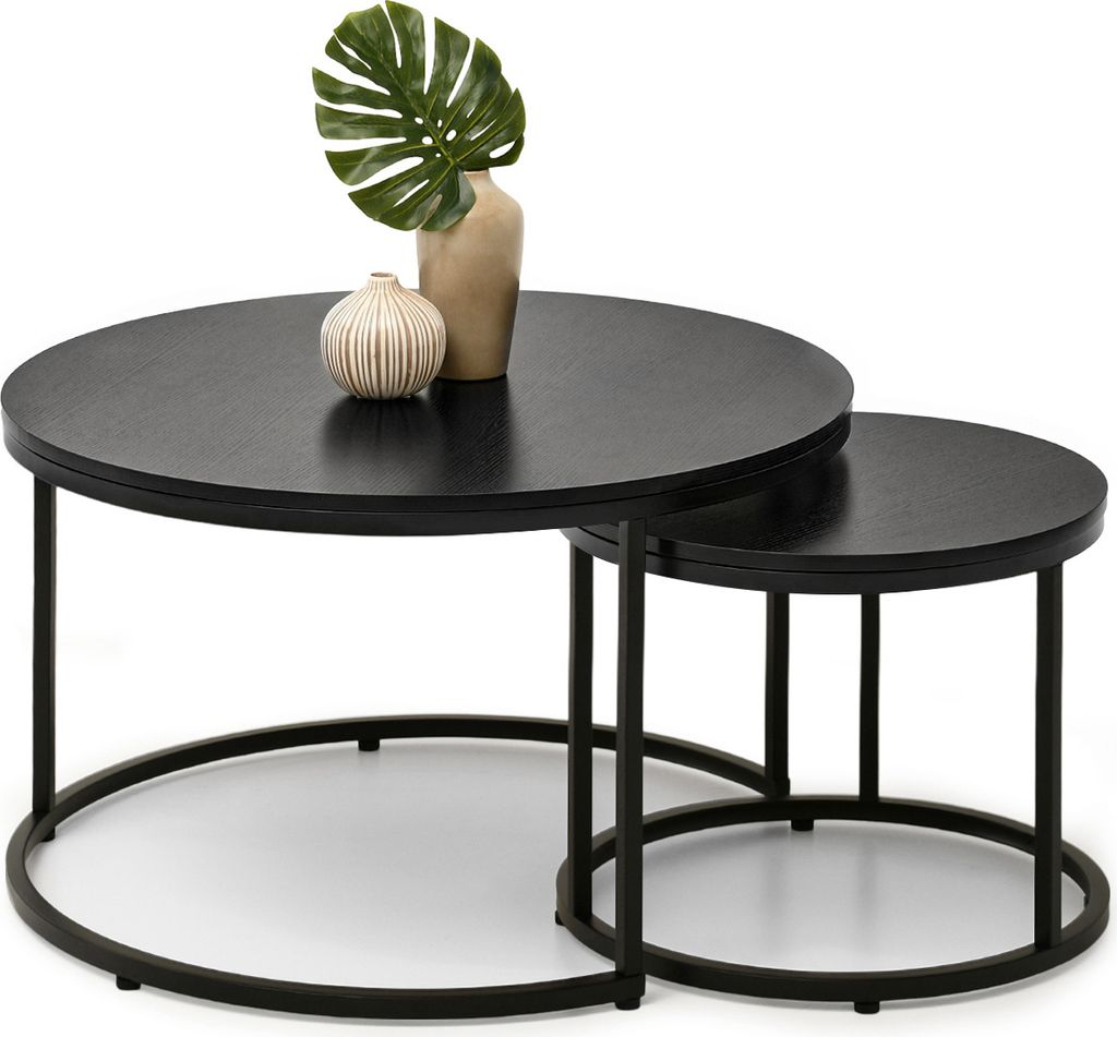 A set of two nesting coffee tables with decorative objects on top.