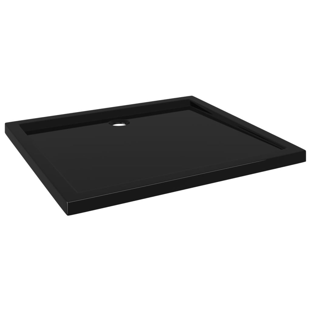 A black rectangular shower tray with a drain hole.