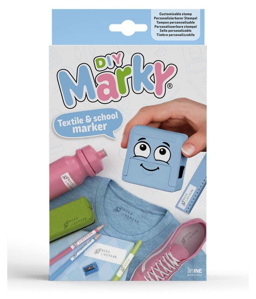 The image shows the product packaging for a DIY Marky textile and school marker set. It displays the product name, a cartoon character, and examples of items that can be marked, such as a t-shirt, water bottle, shoes, and pencils.