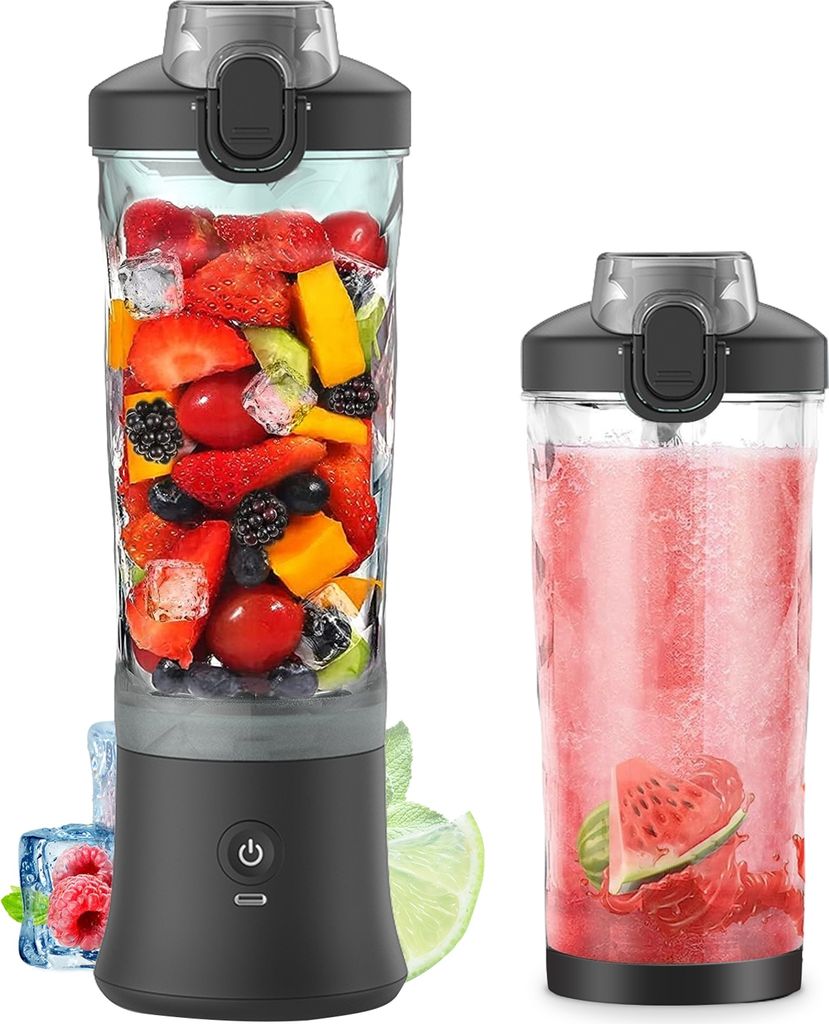 A portable blender filled with fruit and ice next to a finished smoothie in a glass.