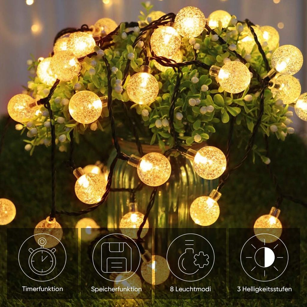 A string of solar-powered LED lights with spherical bulbs, displayed around a potted plant.